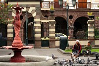 Stone arches, fountain and pigeons at Parque Juan Montalvo in Ambato.