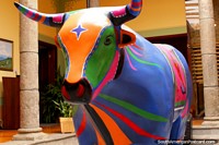 Versão maior do Um modelo de vaca colorido em monitor em um museu em Ambato.