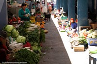 An aisle of vegetables for sale at market San Alfonso in Riobamba. Ecuador, South America.