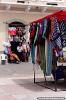 Larger version of Shawls and hammocks for sale at Plaza Roja in Riobamba.