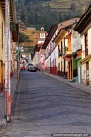 View up a street to the church clock tower in Alausi. Ecuador, South America.