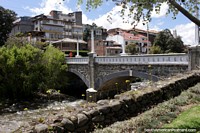 Ponte de pedra sobre o rio que separa a cidade do Parque de la Madre em Cuenca. Equador, América do Sul.