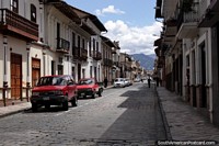 Cobblestone street and footpath and nice building facades in Cuenca. Ecuador, South America.
