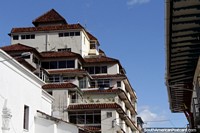 An apartment building with an interesting style that blends into the Cuenca city-scape. Ecuador, South America.