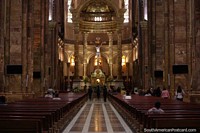 The golden altar and stone surroundings of the Cuenca cathedral. Ecuador, South America.