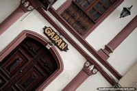Ecuador Photo - Dark wooden door and window, facade with columns and lamps in Cuenca, Gaban.