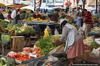A woman sets up her vegetable stand at the Pujili market.