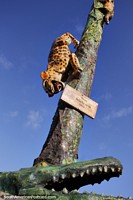 The fight in the jungle, a tiger escapes a crocodile, totem pole at central park, Jama.