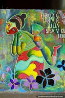 Larger version of Woman carrying child on her back, street art with amazing colors and design in Machala.