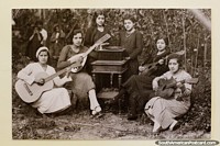 Banda feminina, velha foto assombrosa que apresenta as senhoras com violões e um gramofone, Loja. Equador, América do Sul.