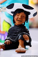 Beggar boy with a black and white hat, crafts for sale at Almacen Artesanal Municipal, Loja.