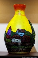 Larger version of Yellow flower vase with a design depicting houses, art at Almacen Artesanal Municipal, Loja.