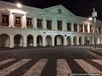 Cotopaxi government building with white facade and arches in Latacunga at night. Ecuador, South America.