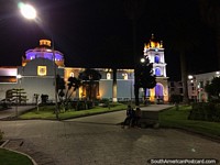White cathedral with colored lights at night beside Vicente Leon Park in Latacunga. Ecuador, South America.