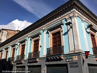 Iron balconies and wooden doors, an historic facade in Quito.