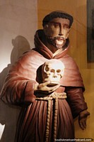 Religious figure holds a skull, antique figure on display at the museum in Pilar.