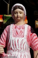 Larger version of Female figure dressed in pink and white, a ceramic figure in Aregua.