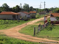 Dirt road and community on the way from Villa Florida to Caapucu. Paraguay, South America.