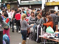 Clothes racks and people, Guasu Markets, Asuncion. Paraguay, South America.
