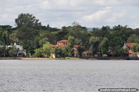 Houses and bush-land on the edge of the lake at San Bernardino, the holiday getaway. Paraguay, South America.