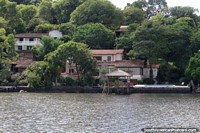 Classy houses surrounded by bush beside the lake at San Bernardino. Paraguay, South America.