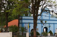 Blue church with trees around it in Caacupe. Paraguay, South America.