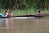 Mum and the kids enjoy the ride along the Napo River in the Amazon.
