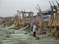 Fishermen getting the nets ready on the banana boats of Huanchaco. Peru, South America.