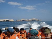 The group speeding away from the Islas Ballestas on the short journey to the mainland. Peru, South America.