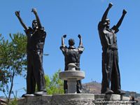 War of San Pablo (1882) monument in Cajamarca, 3 men hold fists in air. Peru, South America.