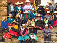 The colorful locals of Huamachuco with their falcon hats watch the street parades. Peru, South America.