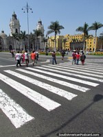 People cross the road towards the Plaza de Armas in Lima. Peru, South America.