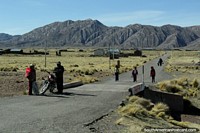 A road and community 20kms west of Desaguadero, kids go home from school. Peru, South America.