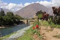 Riverbank in Huanuco, the bridge and mountain, picturesque scene. Peru, South America.