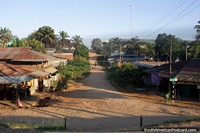 Small town with a dirt road and palm trees between Pucallpa and Aguaytia. Peru, South America.