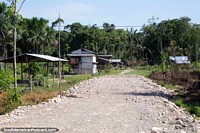 A community of wooden houses around a gravel road near Aguaytia, between Pucallpa and Tingo Maria. Peru, South America.