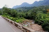Rocky river and thick jungle beside the road to Yurimaguas from Tarapoto. Peru, South America.
