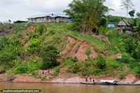 Villagers down by the water, houses on the hill, an hour down river from Yurimaguas at 13kmph.