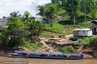 A large river boat for passengers parked in front of a yard north of Yurimaguas. Peru, South America.