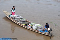 Um barco de rio cheio com produz a chegada ou a partida de Maipuco no Rio Maranon no Amazônia. Peru, América do Sul.