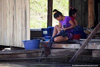 A woman washed clothes beside the river in San Pablo de Loreto, between Iquitos and Santa Rosa. Peru, South America.