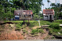 Look closely, there is a cellphone tower in this Amazon community between Iquitos and Santa Rosa. Peru, South America.