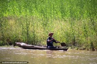An old Peruvian man rows a wooden canoe in the Amazon River in Chimbote, 126kms west of Santa Rosa. Peru, South America.