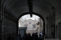 San Francisco church seen from the archways around the Plaza de Armas in Arequipa. Peru, South America.