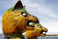 Heads of a dragon boat, the vehicle of choice for the Uros people of Lake Titicaca in Puno. Peru, South America.