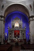 Interior of the cathedral in Puno with blue lighting and arches.