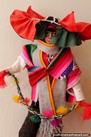 Male dancer with head wear, colorful clothes and woolen pompoms, doll at the Carlos Dreyer Museum, Puno. Peru, South America.