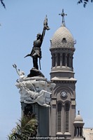 Clock tower and great monument in Lima, man with a gun and flag.