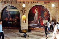 Large paintings inside arches in the foyer of the castle in Lamas. Peru, South America.