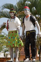Man and woman in traditional clothing, monument at Wayku plaza in Lamas. Peru, South America.
